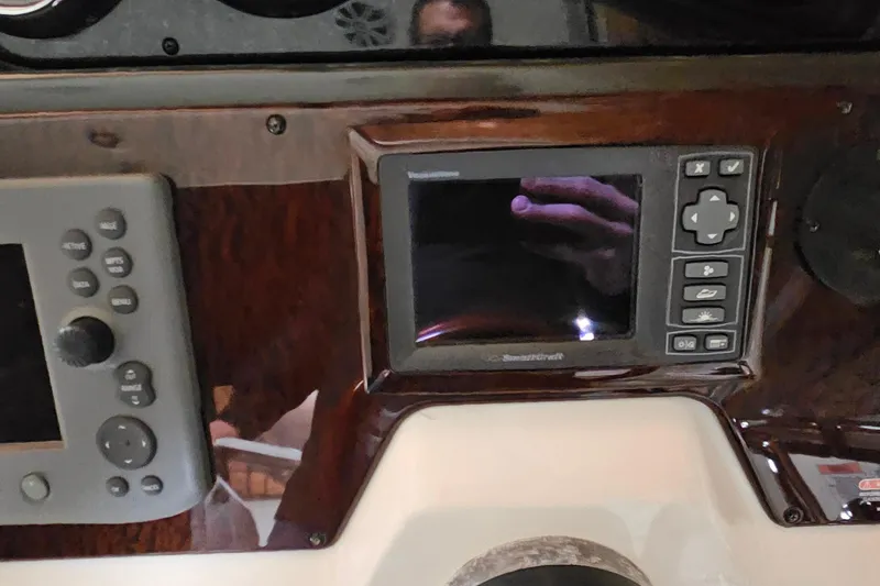 Slide: The Image of 2010 Sea Ray Sundancer 310 dashboard with control panel and display screen. - 10