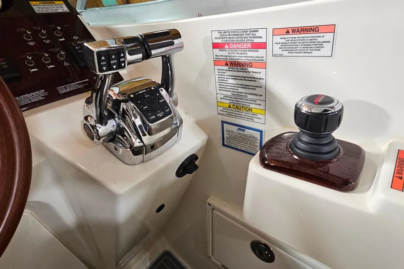 Slide: The Image of Control panel of a 2010 Sea Ray Sundancer 310 boat with throttle and joystick. - 12