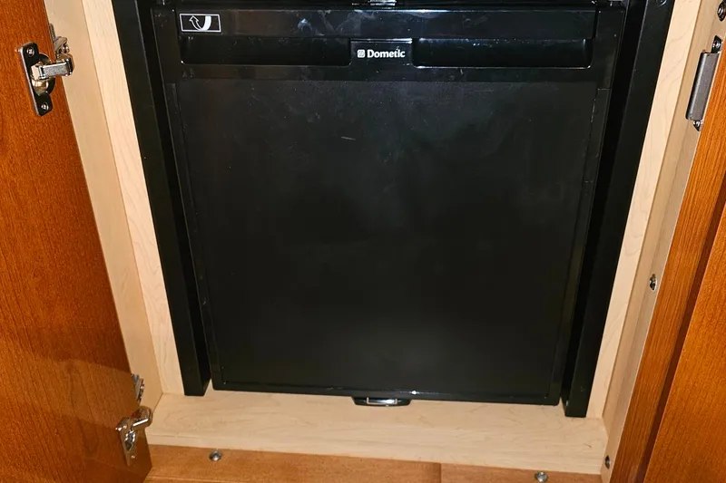 Slide: The Image of 2010 Sea Ray Sundancer 310 interior with kitchenette, seating, and modern amenities. - 25