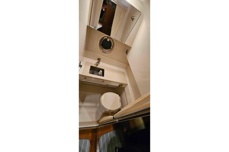 Slide: The Image of Bathroom interior of 2010 Sea Ray Sundancer 310 yacht, featuring sink and toilet. - 26