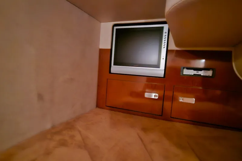 Slide: The Image of Interior of 2010 Sea Ray Sundancer 310 with TV and wooden cabinetry. - 28