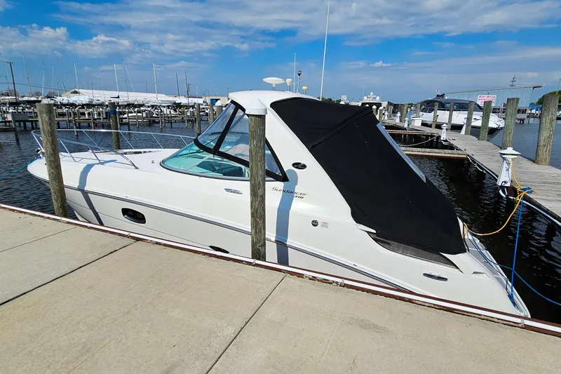 Slide: The Image of 2010 Sea Ray Sundancer 310 docked at marina under clear blue sky. - 35