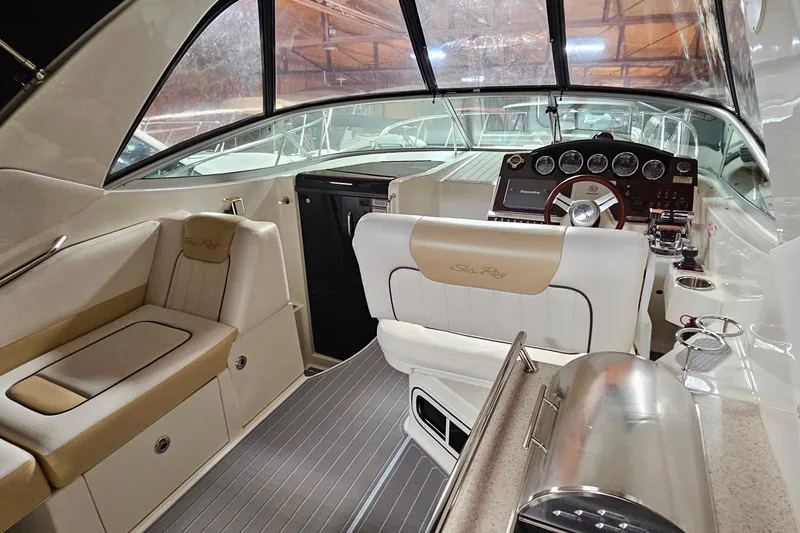 Slide: The Image of Interior of 2010 Sea Ray Sundancer 310 boat, featuring helm and seating area. - 8