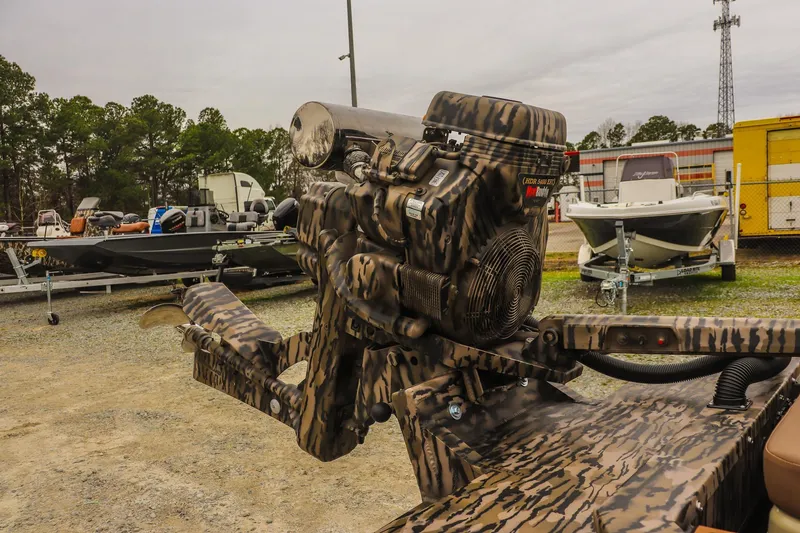 Slide: The Image of Camouflage-patterned Excel 1751 F4 Pro boat engine, 2026 model, in a boatyard setting. - 11