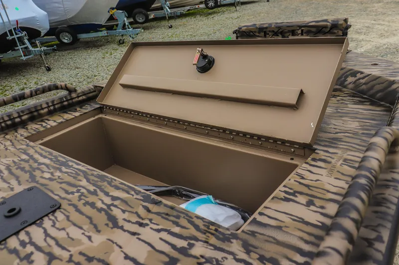 Slide: The Image of Open storage compartment on 2026 Excel 1751 F4 Pro boat, featuring camouflage design. - 14