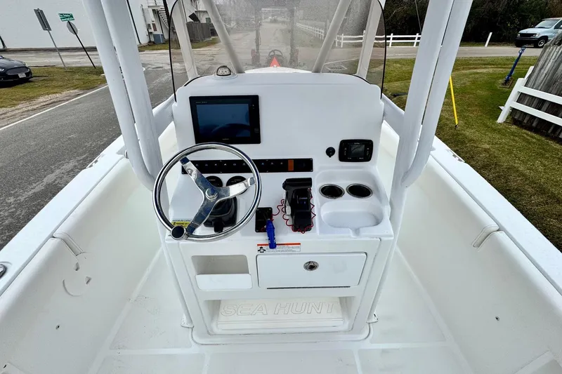 Slide: The Image of 2016 Sea Hunt Ultra 211 boat console with steering wheel and navigation equipment. - 10