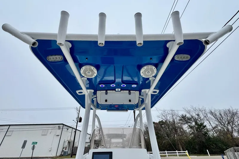 Slide: The Image of 2016 Sea Hunt Ultra 211 boat with blue T-top and rod holders. - 11