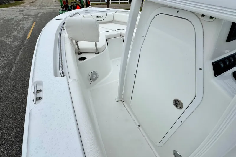Slide: The Image of 2016 Sea Hunt Ultra 211 boat interior with seating and storage compartment. - 12