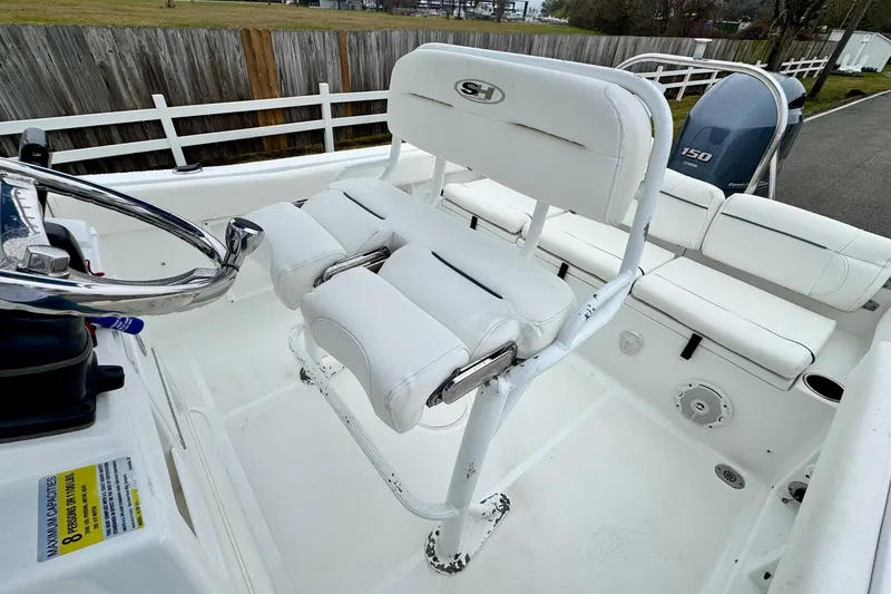 Slide: The Image of 2016 Sea Hunt Ultra 211 boat interior with white seating and steering wheel. - 9