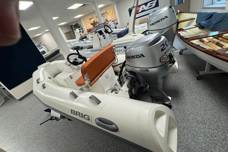 Slide: The Image of 2026 Brig Falcon 330 inflatable boat with Honda outboard motor in showroom. - 3
