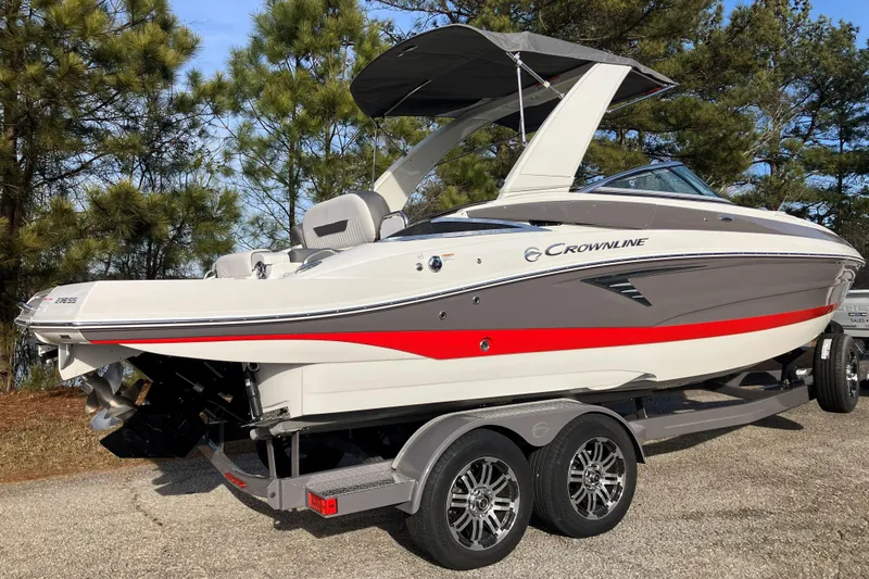 Slide: The Image of 2026 Crownline 220 SS boat on trailer, featuring sleek design and vibrant red accents. - 4