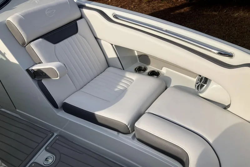 Slide: The Image of 2026 Crownline 220 SS boat interior with luxurious white seating and cup holders. - 9