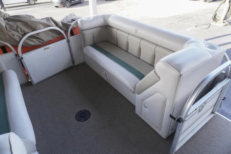 Slide: The Image of Interior of a 2000 Sundancer Pontoons 240 Majestic with cushioned seating. - 12