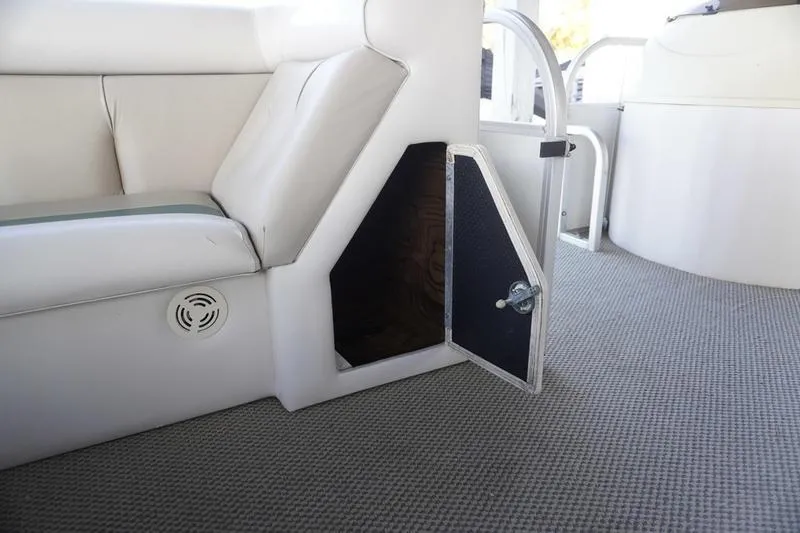 Slide: The Image of Interior of 2000 Sundancer Pontoons 240 Majestic with open storage compartment. - 14