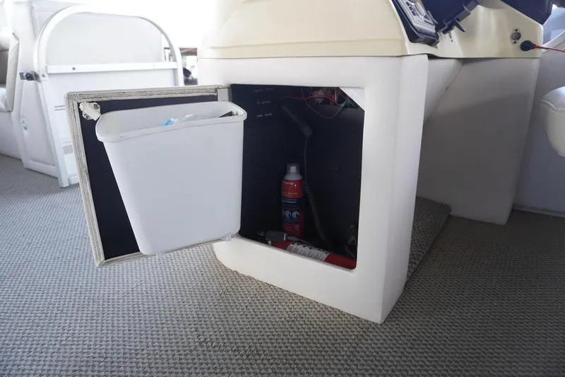 Slide: The Image of Storage compartment on 2000 Sundancer Pontoons 240 Majestic with trash bin and fire extinguisher. - 18