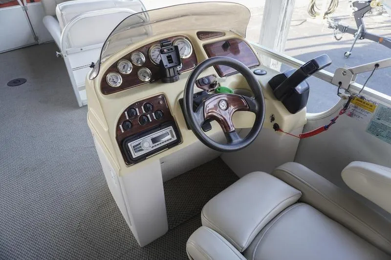 Slide: The Image of Cockpit of 2000 Sundancer Pontoons 240 Majestic with steering wheel and control panel. - 19
