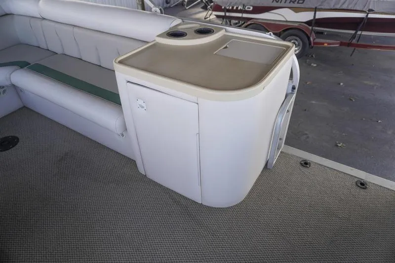 Slide: The Image of Interior of 2000 Sundancer Pontoons 240 Majestic with seating and storage unit. - 21
