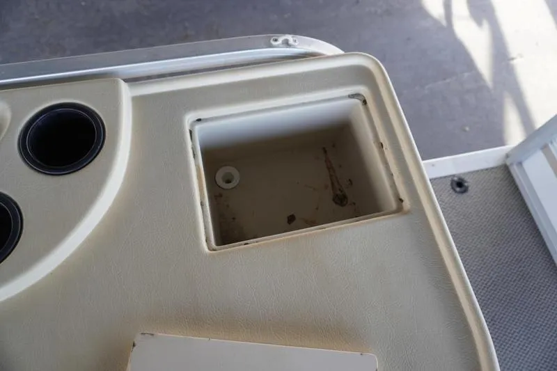 Slide: The Image of Console detail of 2000 Sundancer Pontoons 240 Majestic with cup holders and storage compartment. - 22