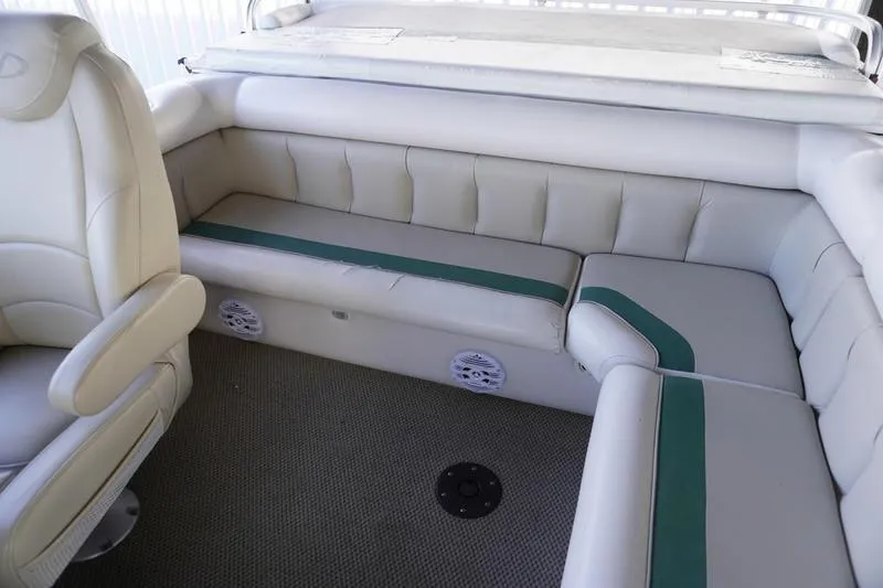 Slide: The Image of Interior seating of 2000 Sundancer Pontoons 240 Majestic with plush upholstery and carpeted flooring. - 26