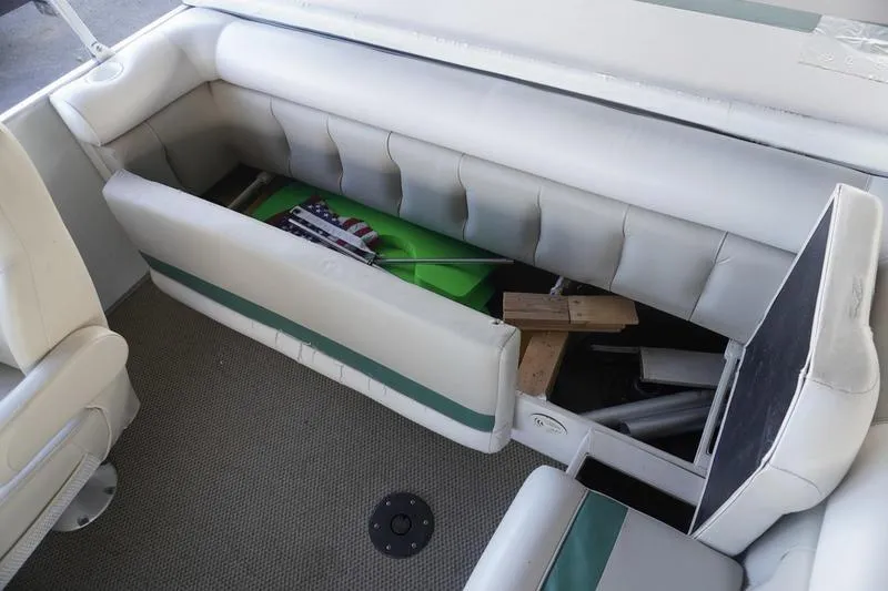 Slide: The Image of Interior of 2000 Sundancer Pontoons 240 Majestic with open storage compartment. - 27