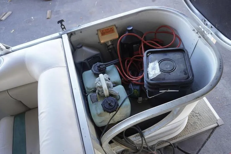 Slide: The Image of Storage compartment of a 2000 Sundancer Pontoons 240 Majestic with fuel tanks and cables. - 30
