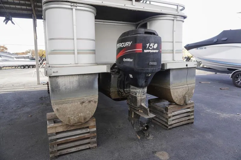 Slide: The Image of 2000 Sundancer Pontoons 240 Majestic with Mercury 150 OptiMax engine on wooden blocks. - 4