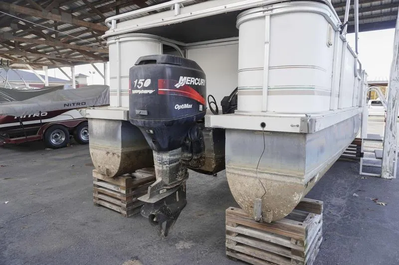 Slide: The Image of 2000 Sundancer Pontoons 240 Majestic with Mercury 150 outboard motor on wooden blocks. - 5