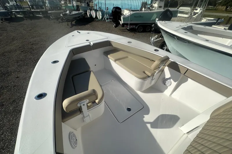 Slide: The Image of 2026 Delta Boatworks Delta D245 boat interior with beige seating and storage compartments. - 10