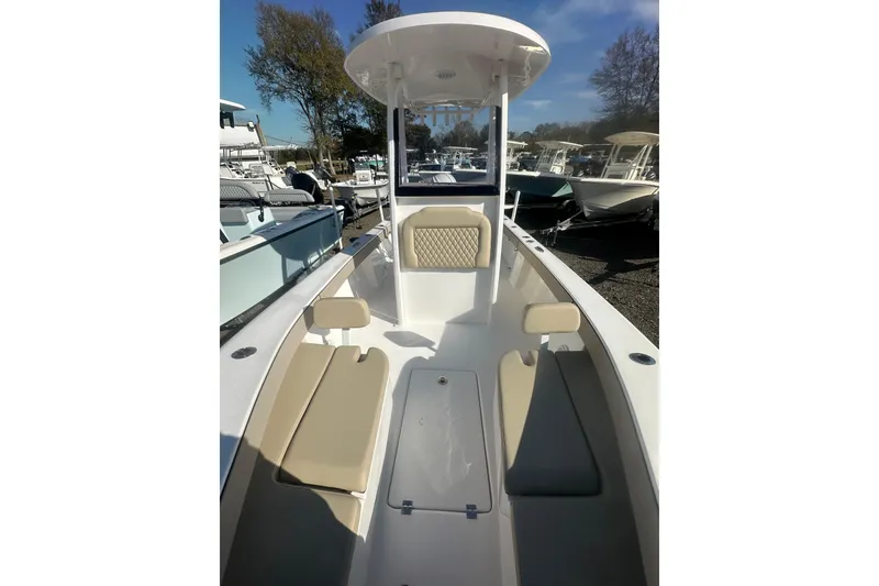 Slide: The Image of 2026 Delta Boatworks Delta D245, sleek interior with beige seating, docked outdoors. - 11