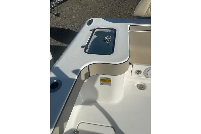 Slide: The Image of 2026 Delta Boatworks Delta D245 deck with storage compartment and seating area. - 14