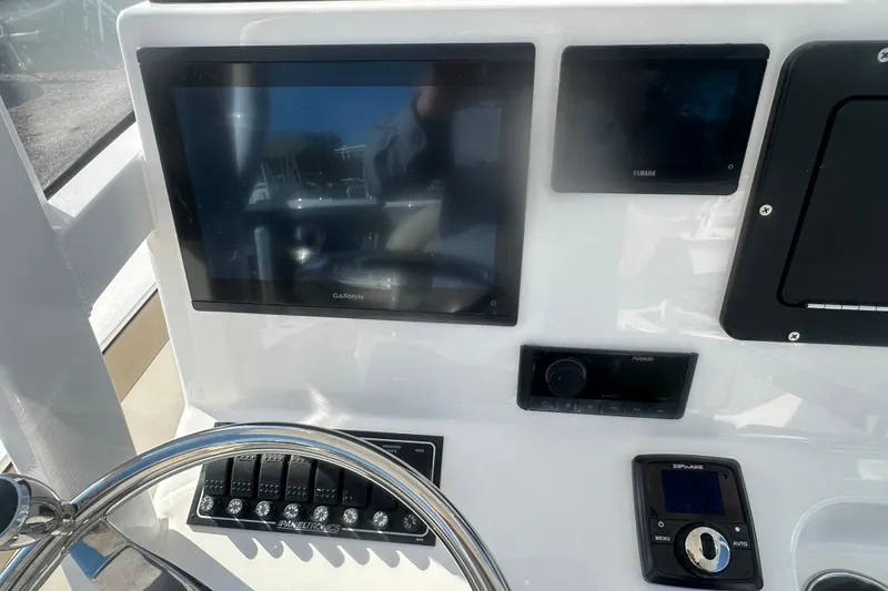Slide: The Image of Control panel of 2026 Delta Boatworks Delta D245 with Garmin and Yamaha displays. - 17
