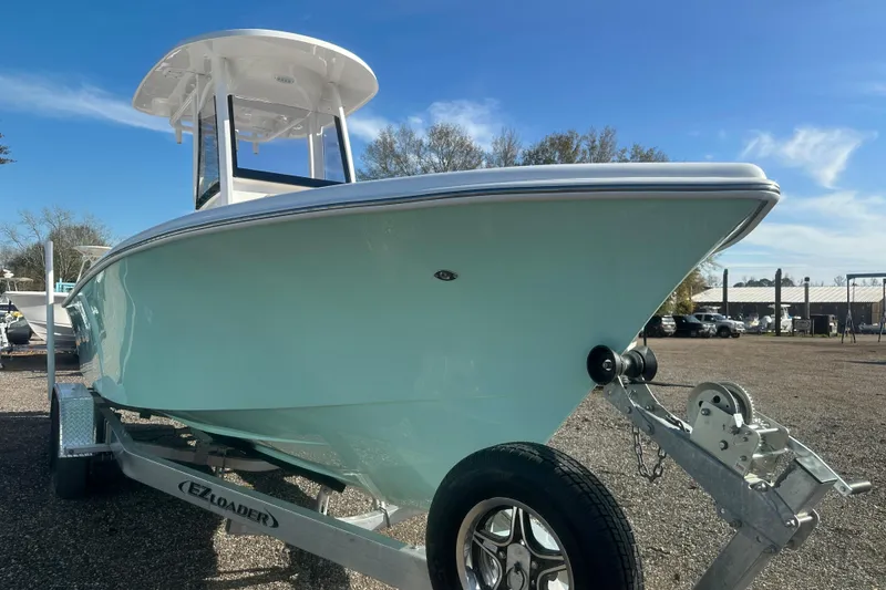 Slide: The Image of 2026 Delta Boatworks Delta D245 on trailer, displayed outdoors under clear blue sky. - 4