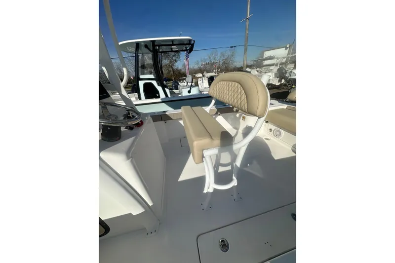 Slide: The Image of 2026 Delta Boatworks Delta D245 interior with beige seating and steering console. - 9