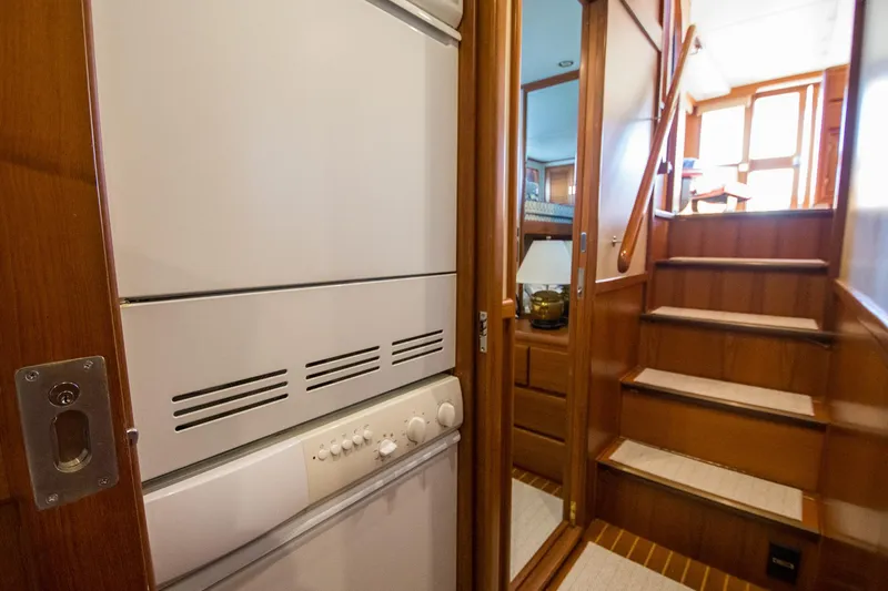 Slide: The Image of Interior of 2000 Fleming 55 yacht with wooden stairs and built-in appliances. - 11