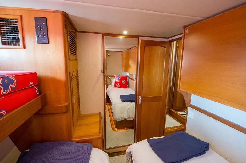 Slide: The Image of Interior of 2000 Fleming 55 yacht with cozy wooden cabin and twin beds. - 15