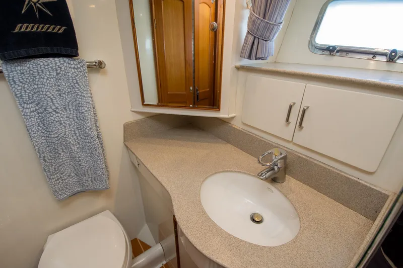 Slide: The Image of Bathroom interior of a 2000 Fleming 55 yacht with sink, mirror, and towel. - 16