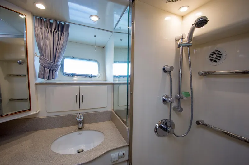 Slide: The Image of Luxurious bathroom in 2000 Fleming 55 yacht with modern fixtures and elegant design. - 17