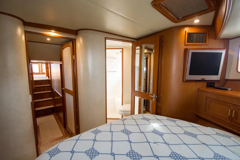 Slide: The Image of Luxurious interior of a 2000 Fleming 55 yacht, featuring a cozy bedroom and modern amenities. - 19