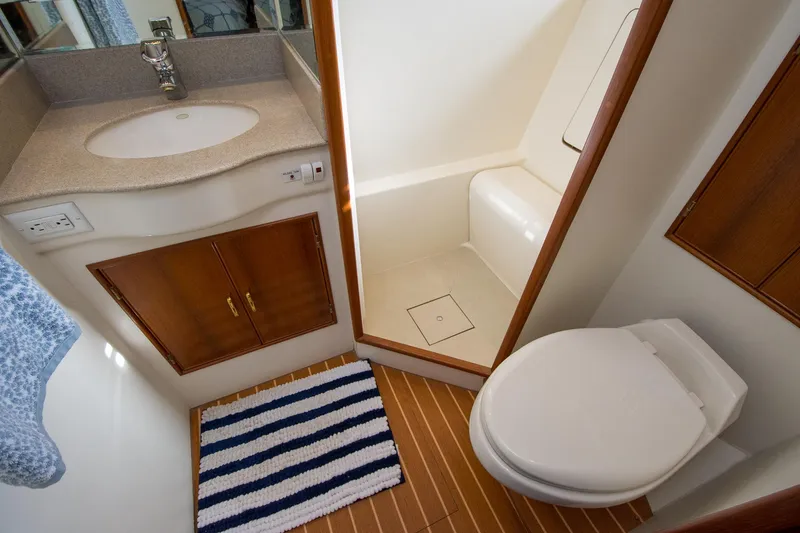 Slide: The Image of Luxurious bathroom in 2000 Fleming 55 yacht with modern fixtures and striped rug. - 20