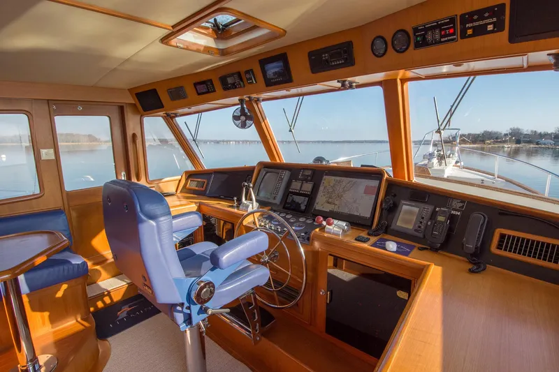 Slide: The Image of Luxurious helm of a 2000 Fleming 55 yacht with navigation equipment and blue captain's chair. - 23