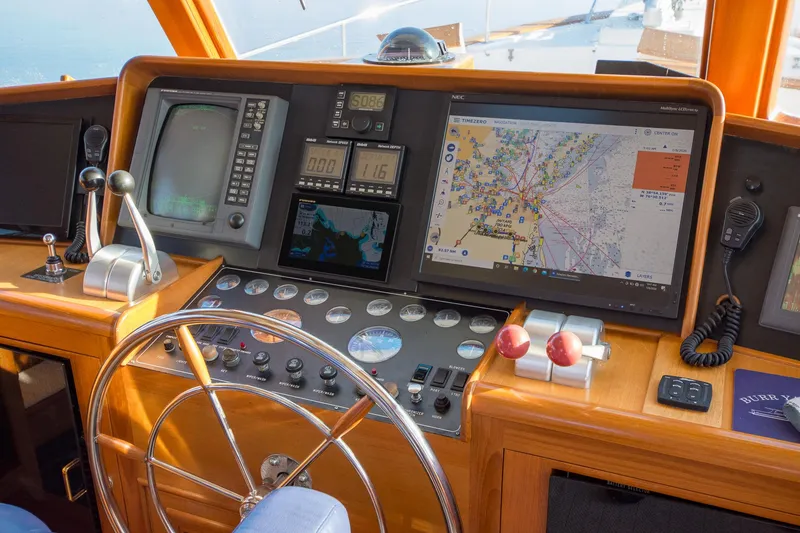 Slide: The Image of Cockpit of a 2000 Fleming 55 yacht with navigation equipment and steering wheel. - 24
