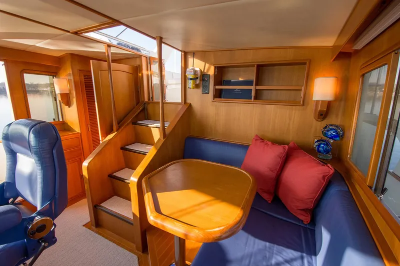 Slide: The Image of Luxurious interior of 2000 Fleming 55 yacht with cozy seating and elegant wood finish. - 25