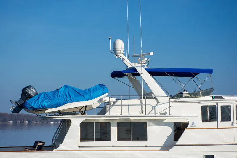 Slide: The Image of Fleming 55 yacht from 2000 with blue canopy and covered dinghy. - 26