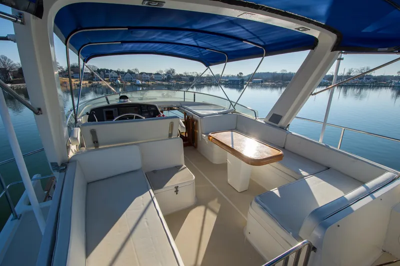 Slide: The Image of Flybridge of 2000 Fleming 55 yacht with blue canopy and seating area. - 30