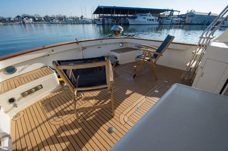 Slide: The Image of Deck of 2000 Fleming 55 yacht with chairs, overlooking marina. - 37
