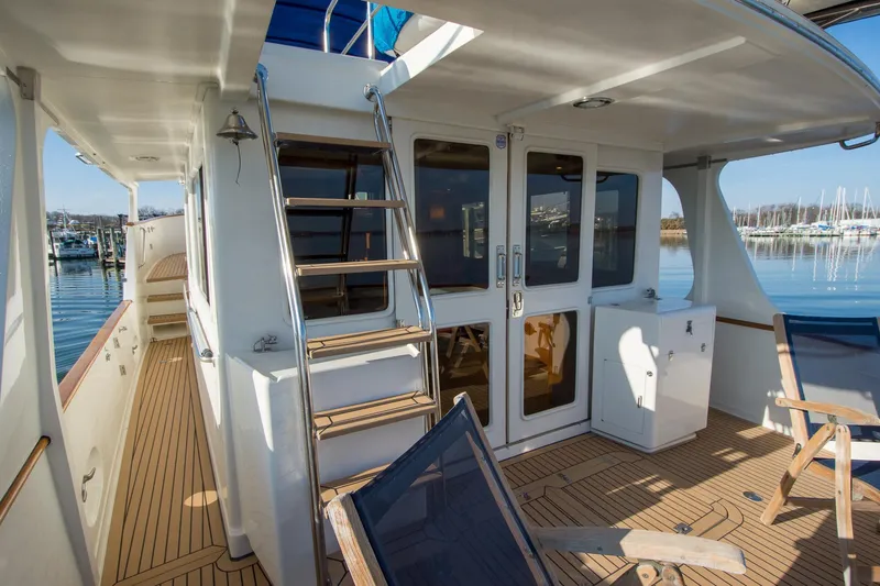 Slide: The Image of Deck view of a 2000 Fleming 55 yacht with wooden flooring and seating. - 38