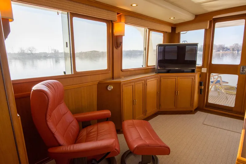 Slide: The Image of Luxurious interior of a 2000 Fleming 55 yacht with leather chair and scenic water view. - 4