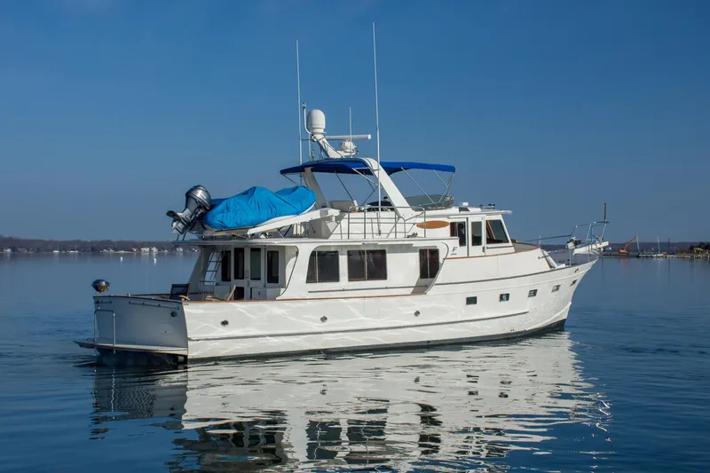 Slide: The Image of 2000 Fleming 55 yacht on calm water under clear blue sky. - 40