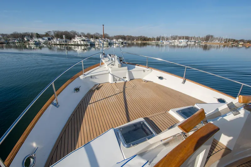 Slide: The Image of Bow view of 2000 Fleming 55 yacht on calm water near marina. - 42