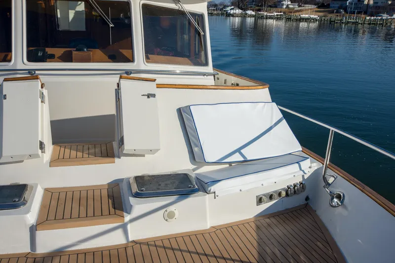 Slide: The Image of Deck of 2000 Fleming 55 yacht with seating and storage, overlooking calm waters. - 43